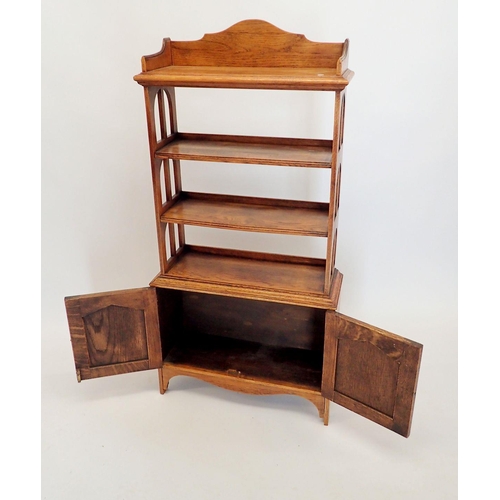 1445 - An early 20th century open oak bookcase with three shelves over cupboard, 60x128cm