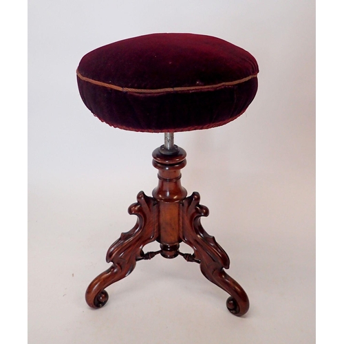 1446 - A Victorian large mahogany revolving piano stool on ornately carved base with triple scroll supports... 