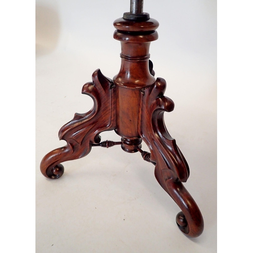 1446 - A Victorian large mahogany revolving piano stool on ornately carved base with triple scroll supports... 