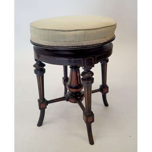 1488 - A Victorian Aesthetic style ebonised revolving piano stool with walnut inlay