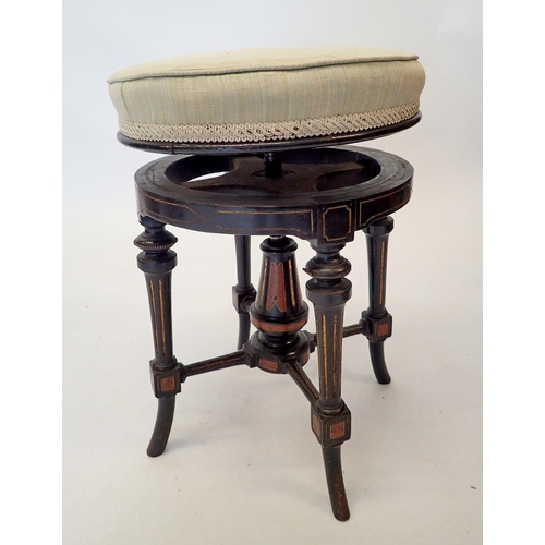 1488 - A Victorian Aesthetic style ebonised revolving piano stool with walnut inlay