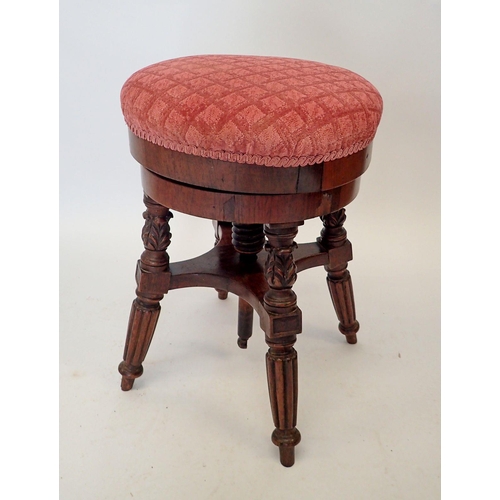 1490 - A Victorian mahogany revolving piano stool on reeded supports