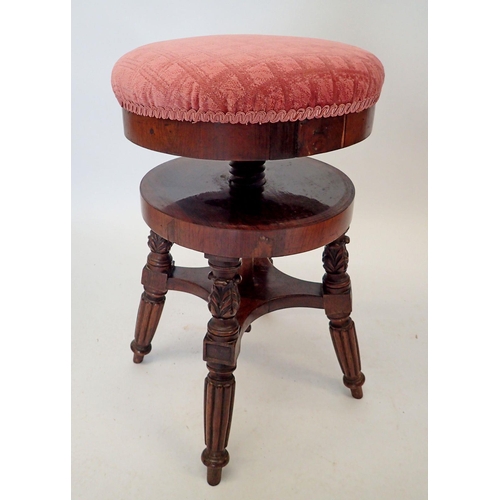 1490 - A Victorian mahogany revolving piano stool on reeded supports