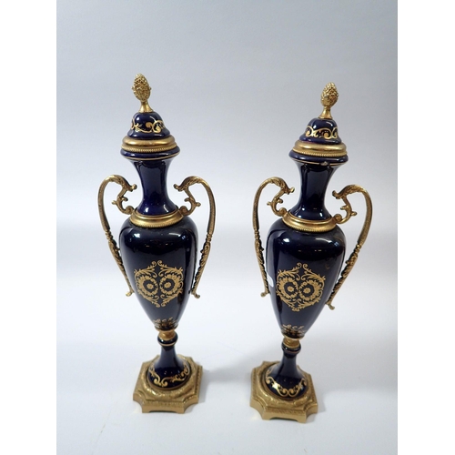 16 - A pair of ACF serves style vases painted reserves of flowers signed Kenzi with gilt metal mounts, 31... 