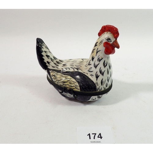 174 - A Limoges trinket box in the form of a chicken with painted decoration, initialed E V, 10cm tall