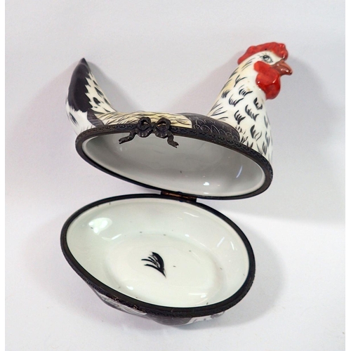 174 - A Limoges trinket box in the form of a chicken with painted decoration, initialed E V, 10cm tall