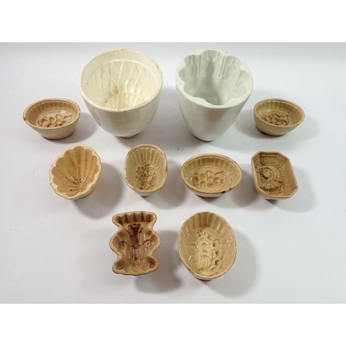 194 - A collection of eight small brown pottery jelly moulds including asparagus, fruits etc and two large... 