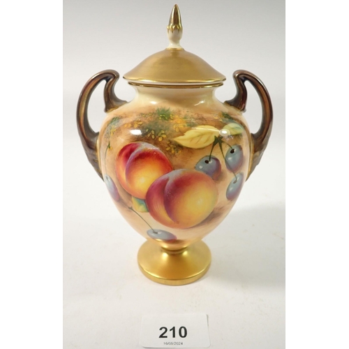 210 - A Royal Worcester two handled urn form vase and cover painted fruit by Roberts, 17cm tall