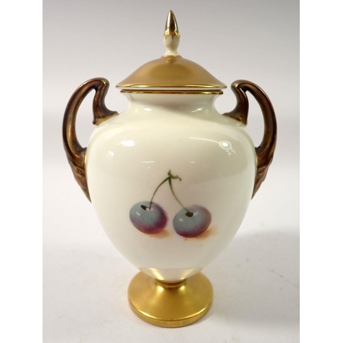 210 - A Royal Worcester two handled urn form vase and cover painted fruit by Roberts, 17cm tall