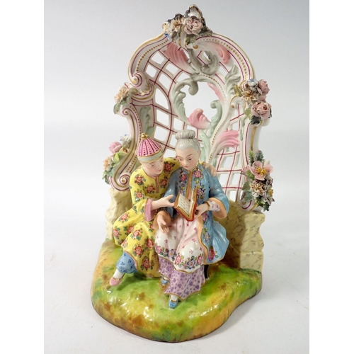 211 - A 19th century Meissen style group of Chinese couple seated reading in floral and scrollwork bower, ... 