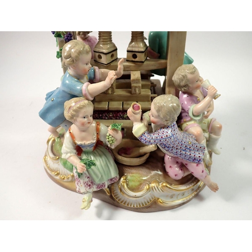 220 - A 19th century Meissen group of children playing around a wine press, crossed swords mark to base, 2... 