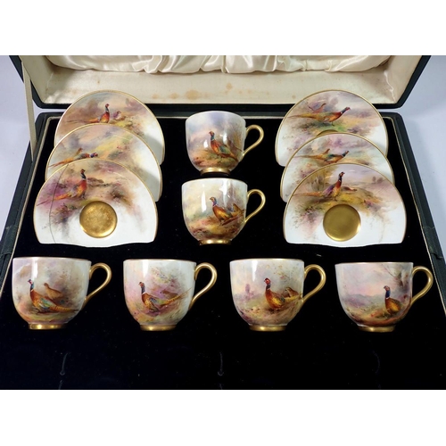 221 - A set of six Royal Worcester coffee cans and saucers painted pheasants by James Stinton in a fitted ... 