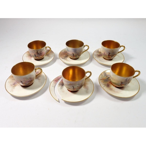 221 - A set of six Royal Worcester coffee cans and saucers painted pheasants by James Stinton in a fitted ... 