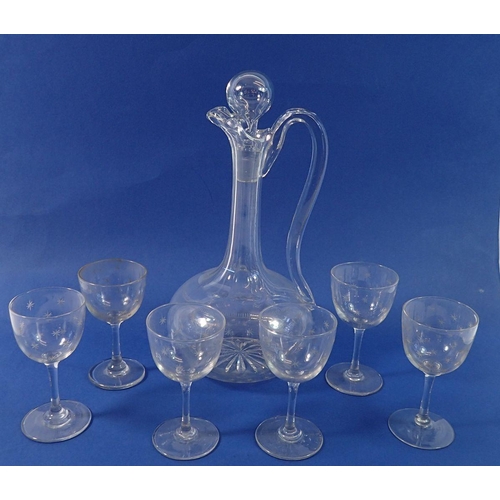 245 - An Edwardian glass decanter and six matching sherry glasses all engraved stars