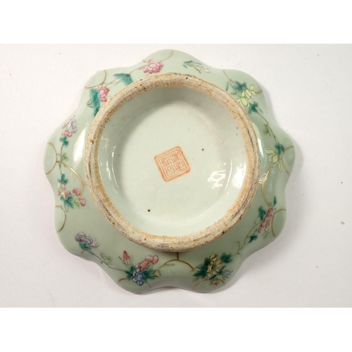 287 - A Chinese Celadon glazed Canton saucer on carved wooden stand, 17cm wide