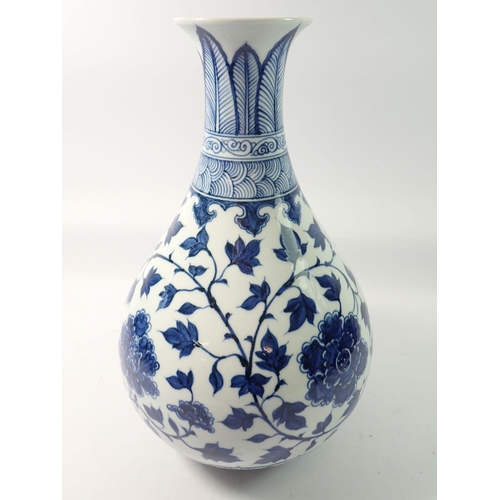 294 - A Chinese blue and white baluster vase decorated peony and trailing leaves, 34cm tall