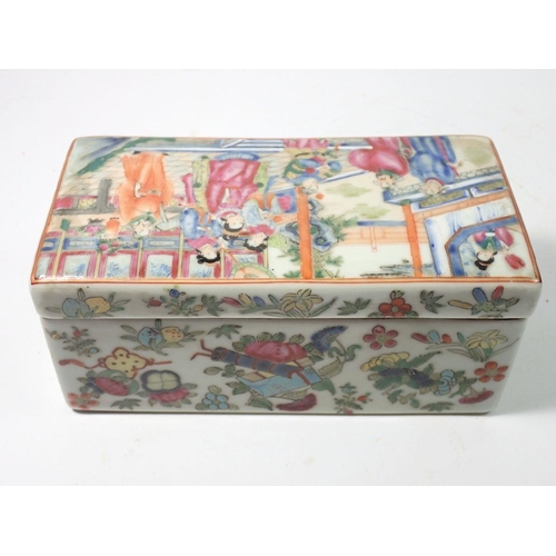 309 - A Chinese 19th century Canton famille rose rectangular box and lid decorated court ladies and offici... 