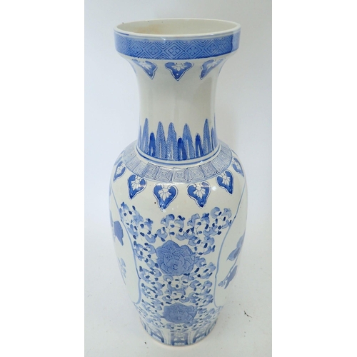 313 - A large blue and white Chinese baluster urn form vase decorated flowers, 62cm tall