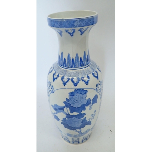 313 - A large blue and white Chinese baluster urn form vase decorated flowers, 62cm tall