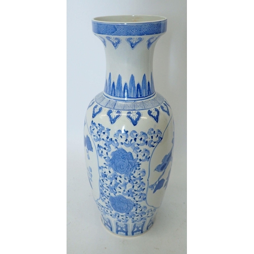 313 - A large blue and white Chinese baluster urn form vase decorated flowers, 62cm tall