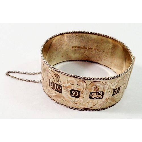 667 - A silver engraved hinged bangle with feature hallmark, Birmingham 1978, 62g