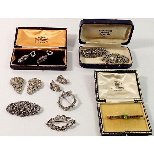 682 - A group of vintage marcasite and paste brooches including one circular silver brooch, SJD earrings e... 