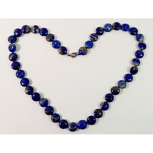 695 - A lapis lazuli bead necklace with silver clasp