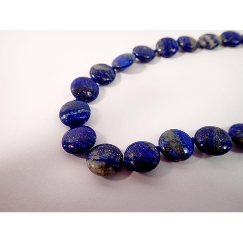 695 - A lapis lazuli bead necklace with silver clasp