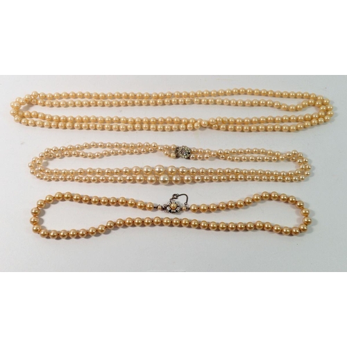 702 - Three vintage pearl necklaces, two with decorative clasps