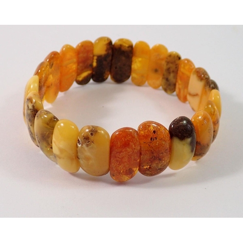 713 - A Baltic amber stretch bracelet, 1.9cm wide, 17g