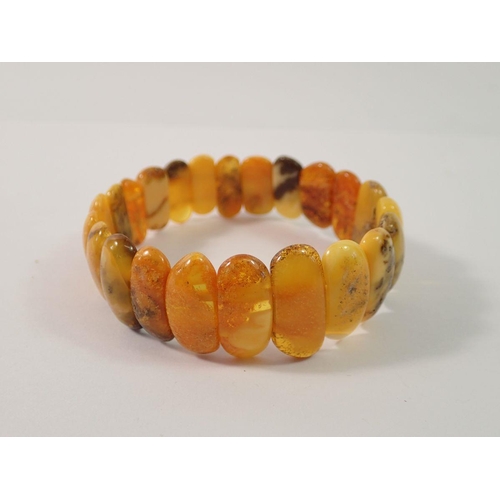 713 - A Baltic amber stretch bracelet, 1.9cm wide, 17g