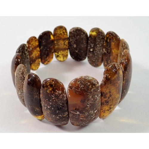 714 - A Baltic black amber stretch bracelet, 3.5cm wide, 30g