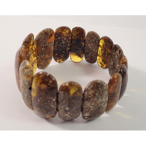 714 - A Baltic black amber stretch bracelet, 3.5cm wide, 30g