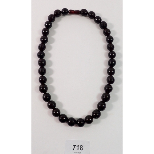 718 - A cherry amber bead necklace, 50cm long, 57g