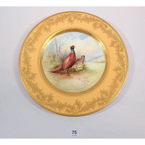 75 - A Minton plate painted pheasants by A Holland within yellow and gilt border, 27cm diameter