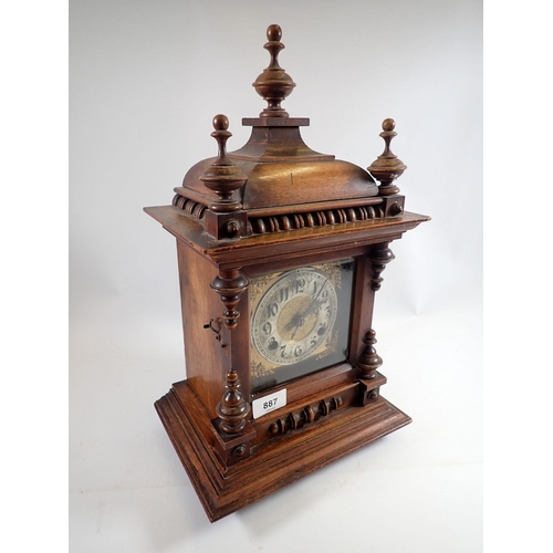 887 - A Victorian mahogany mantel clock with turned decoration by Camerer Cuss, 45cm tall