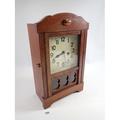 888 - An Edwardian oak shelf clock with glazed door, 35cm tall