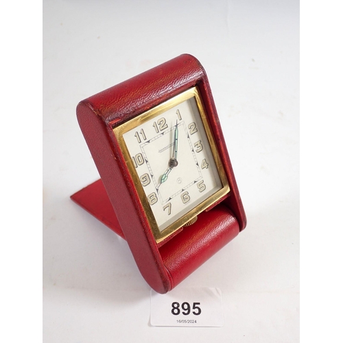 895 - An Art Deco Jaeger le Coultre travel clock in red leather case