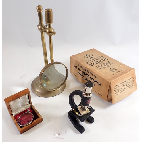 905 - A brass magnifying glass on stand and a students microscope etc.