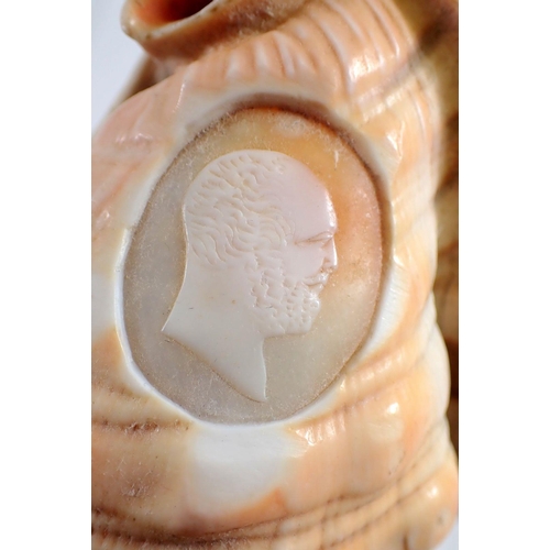 934 - A conch shell carved with a cameo of a man, 12cm tall