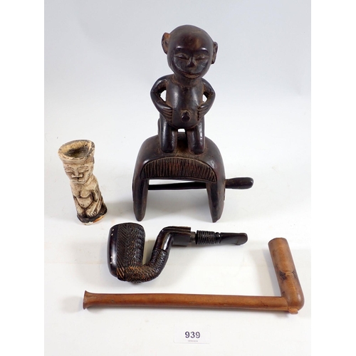 939 - A group of four tribal items comprising figurative heddle weaving pulley, a Shona Nguni carved pipe,... 