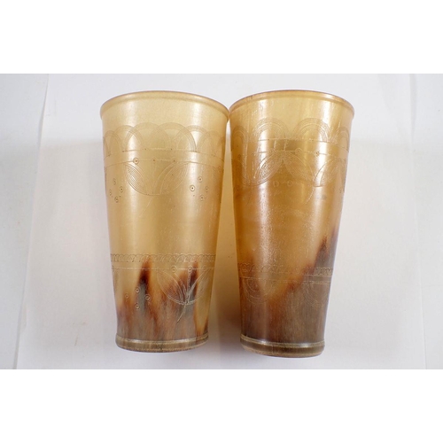 966 - Two engraved horn beakers, 11cm tall