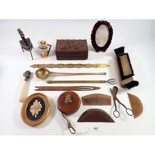 997 - A box of collectables including tape measure, treen combs, carved box etc.