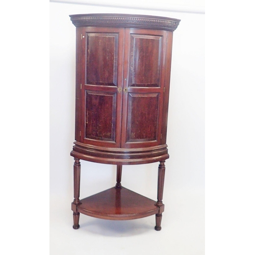 1091 - A 19th century bow fronted mahogany corner cabinet with unusual hinged secret compartment to frieze ... 