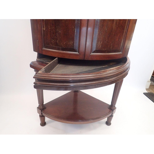 1091 - A 19th century bow fronted mahogany corner cabinet with unusual hinged secret compartment to frieze ... 