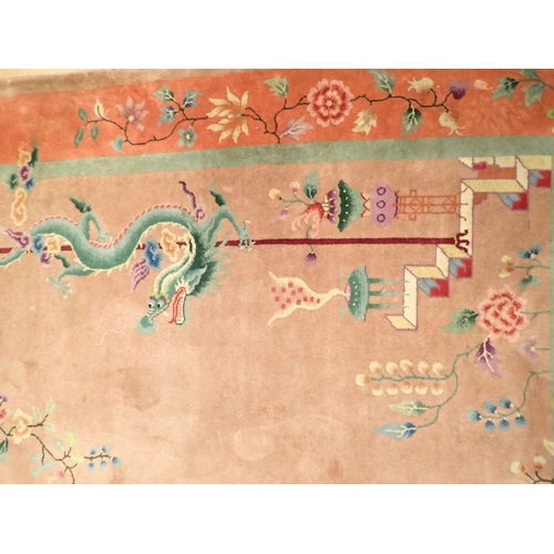 1404 - A Chinese large rug with dragons and flowers on dusty pink ground, 266 x 184cm