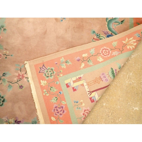 1404 - A Chinese large rug with dragons and flowers on dusty pink ground, 266 x 184cm