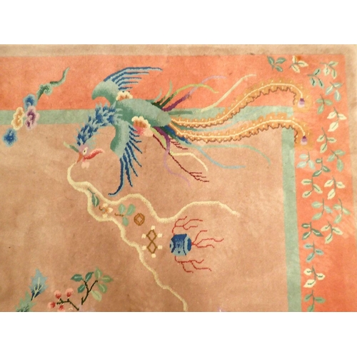 1404 - A Chinese large rug with dragons and flowers on dusty pink ground, 266 x 184cm