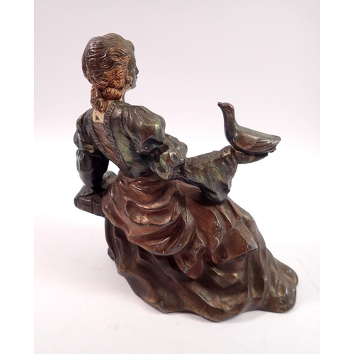 1080 - A spelter figure of seated lady with dove, 15.5cm tall