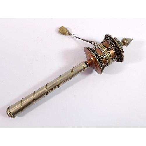 1090 - A Tibetan white metal prayer wheel, 17cm long